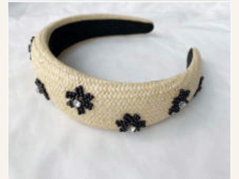 Cream textured headband with black floral details development sample