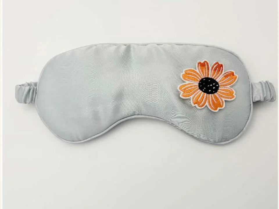 Silver satin sleep mask with applied orange flower development sample